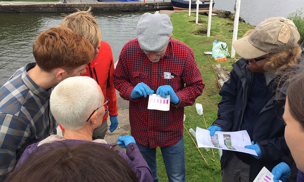A group of people being trained in water quality